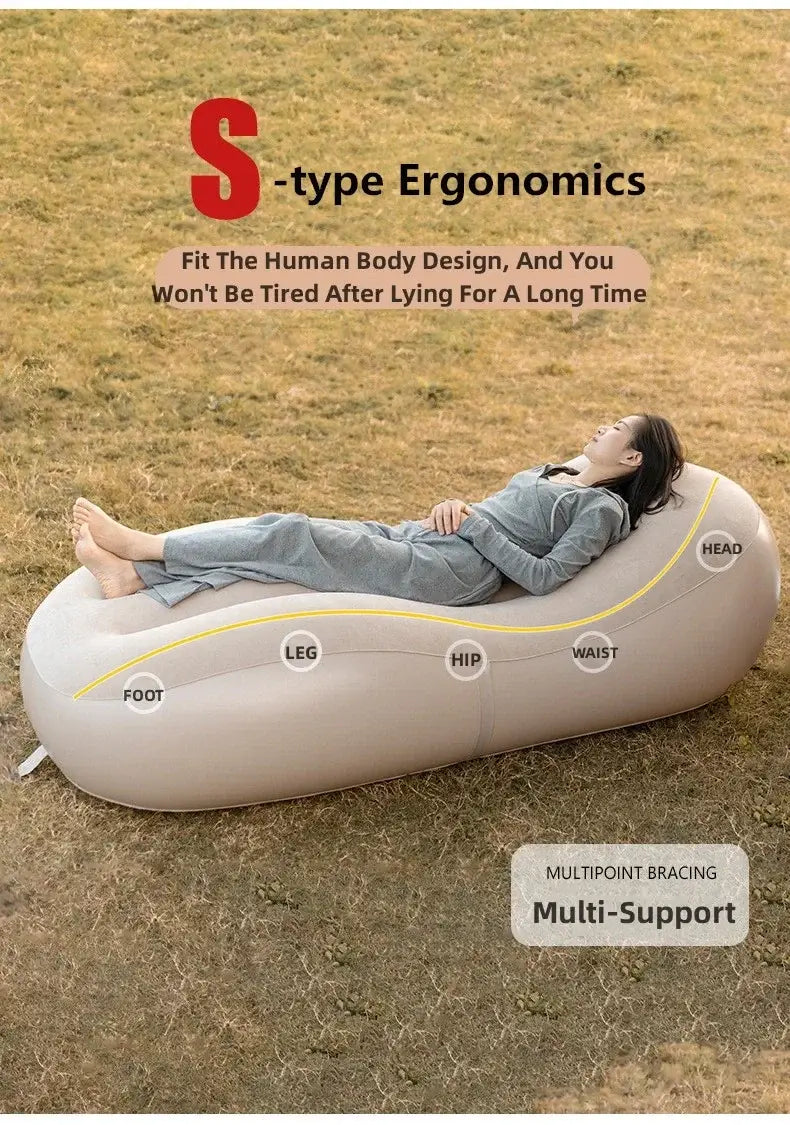 Woman relaxing on an S-type ergonomic inflatable sofa bed designed for comfort and support during long use.