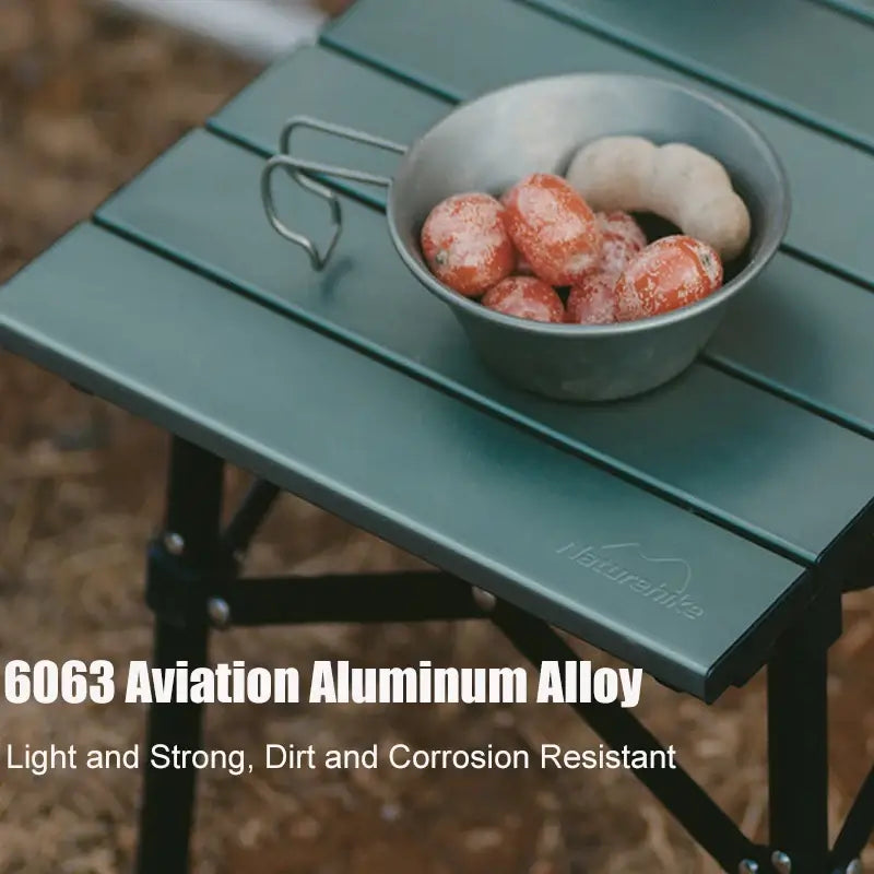 Naturehike aluminum alloy folding table showcasing durability and resistance, with a bowl of food on the surface for camping use.