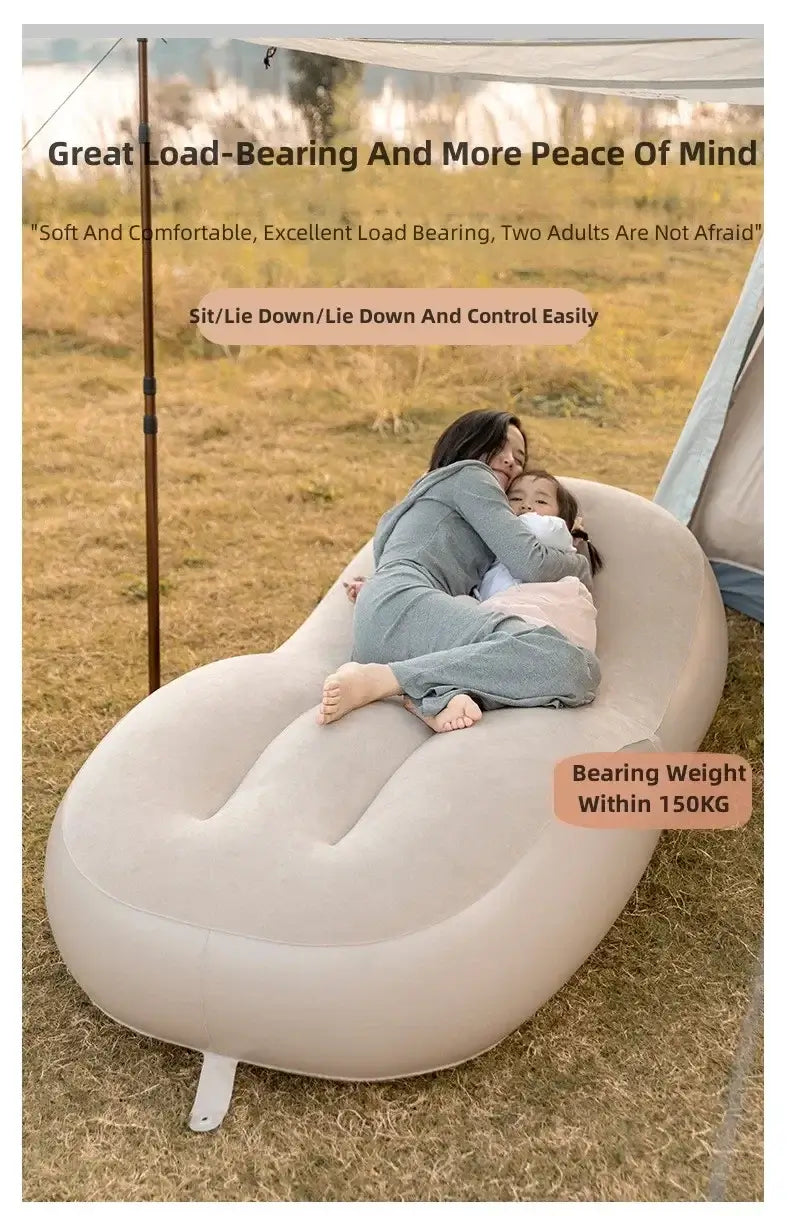 Comfortable inflatable air sofa bed supporting up to 150KG, featuring two adults relaxing outdoors.