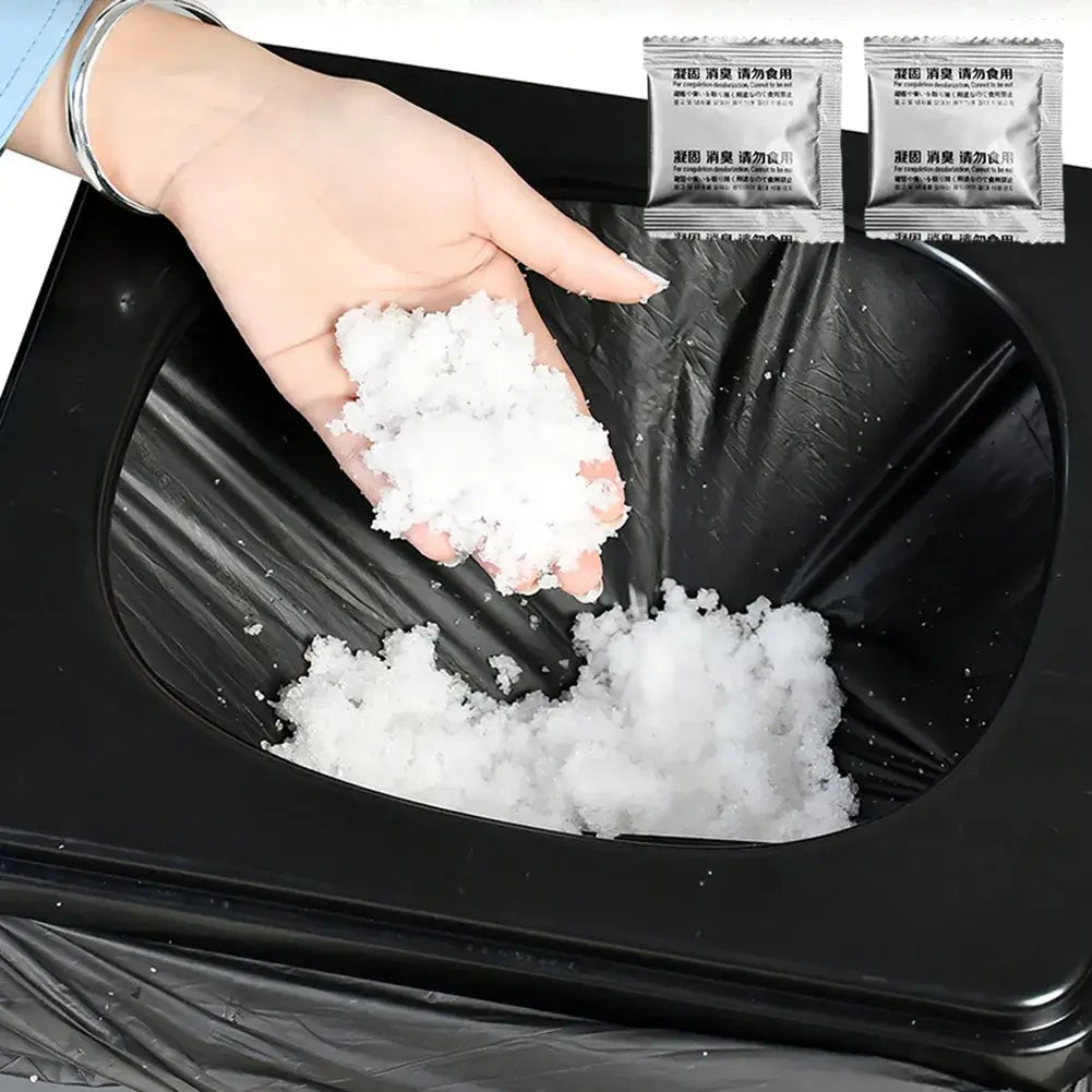 Person holding eco absorbent gel for portable toilets over a black trash bag, showcasing easy waste treatment solution.