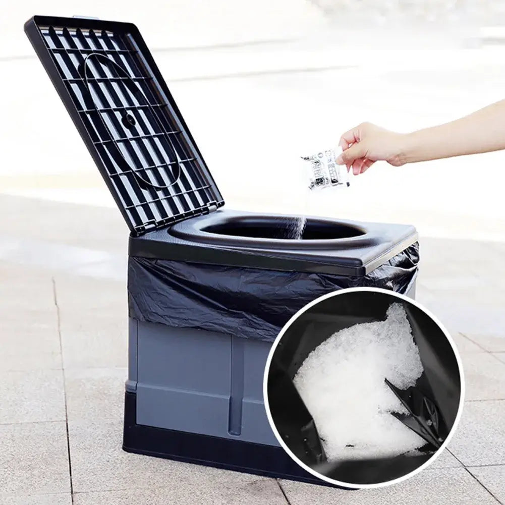 Portable camping toilet with black waste bag, hand adding eco absorbent gel for waste treatment.